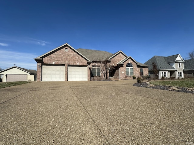 view of front of house with brick siding, driveway, and an attached garage