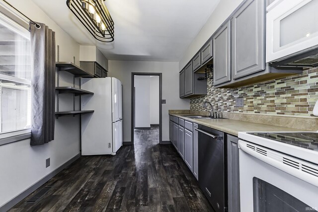 kitchen featuring white appliances, dark wood-style floors, open shelves, gray cabinets, and a sink