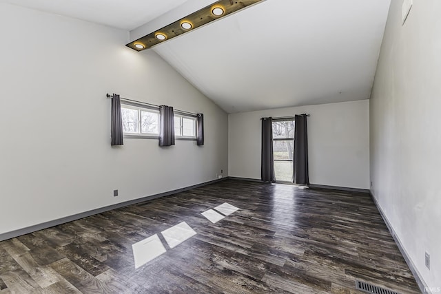 unfurnished room featuring dark wood finished floors, vaulted ceiling with beams, and baseboards