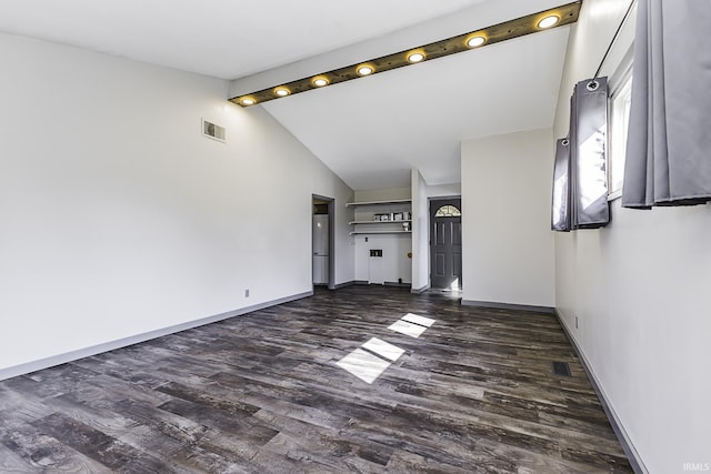 unfurnished living room featuring dark wood finished floors, lofted ceiling with beams, baseboards, and visible vents