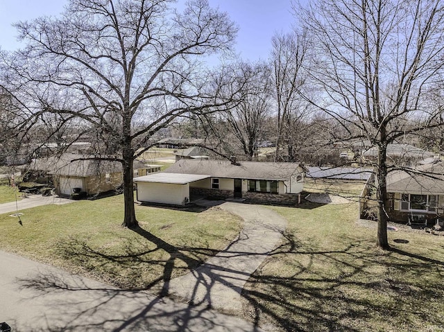 view of front of property with aphalt driveway, a front lawn, and stone siding