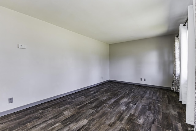 spare room with dark wood finished floors