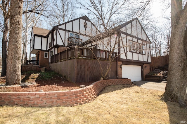 view of side of property with stucco siding, driveway, an attached garage, a shingled roof, and brick siding