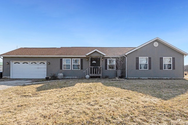 ranch-style home with an attached garage, gravel driveway, and a front lawn