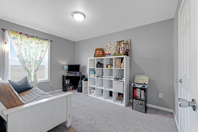 carpeted home office featuring baseboards