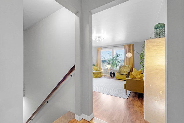 staircase with baseboards and wood finished floors