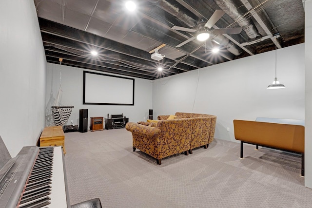 home theater room with ceiling fan and carpet floors