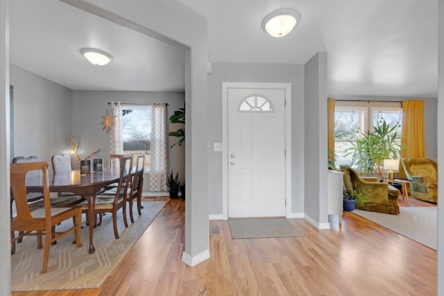 entrance foyer with baseboards and light wood-style floors