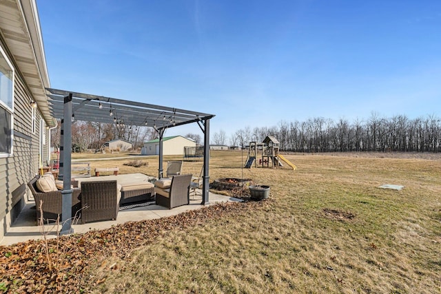 view of yard featuring outdoor lounge area, a patio, a playground, and a pergola