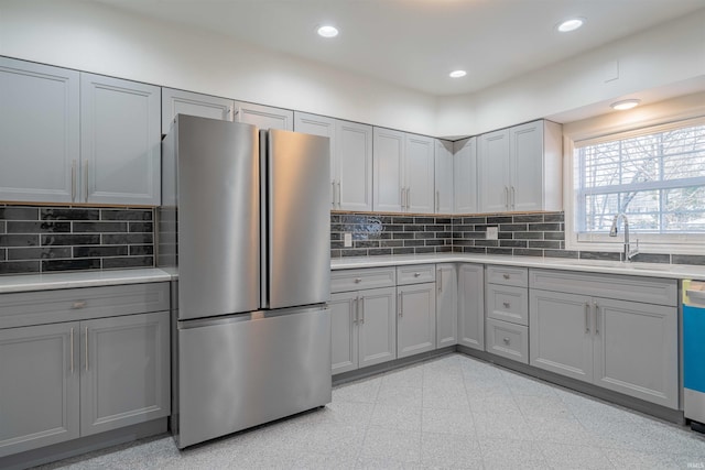 kitchen with a sink, stainless steel appliances, recessed lighting, and gray cabinets