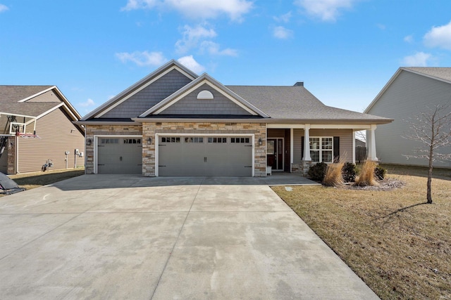 craftsman-style home featuring a porch, concrete driveway, a front lawn, a garage, and stone siding