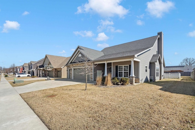 view of front of home featuring a front lawn, fence, a chimney, a garage, and driveway