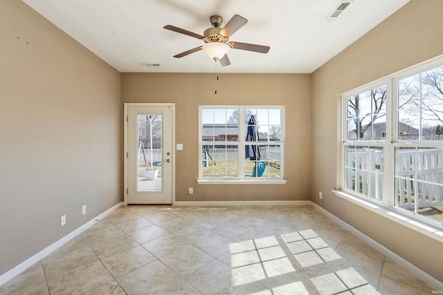 unfurnished sunroom with visible vents and a ceiling fan