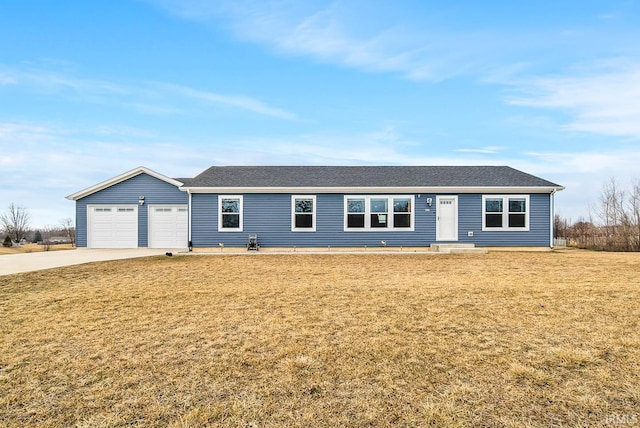 single story home with an attached garage, concrete driveway, and a front yard