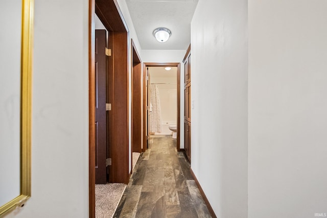 hallway featuring baseboards