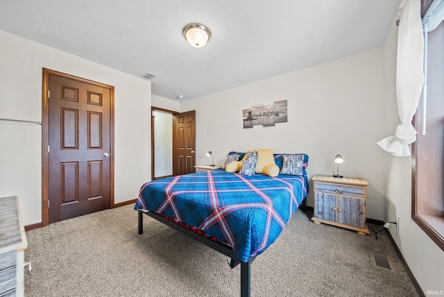 bedroom featuring visible vents, carpet flooring, and baseboards