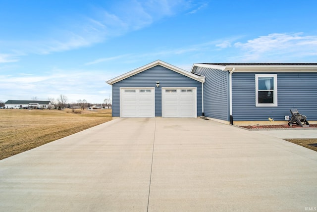 view of front of home with a detached garage and a front yard