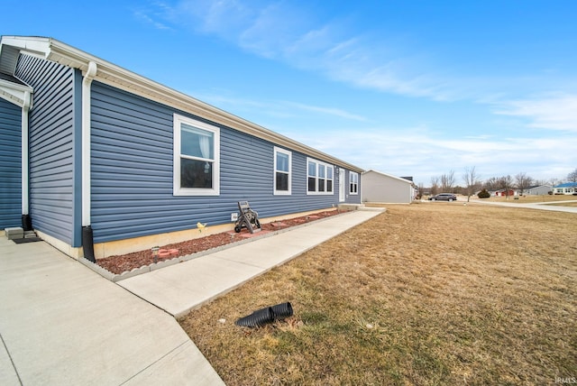 view of side of property with a lawn