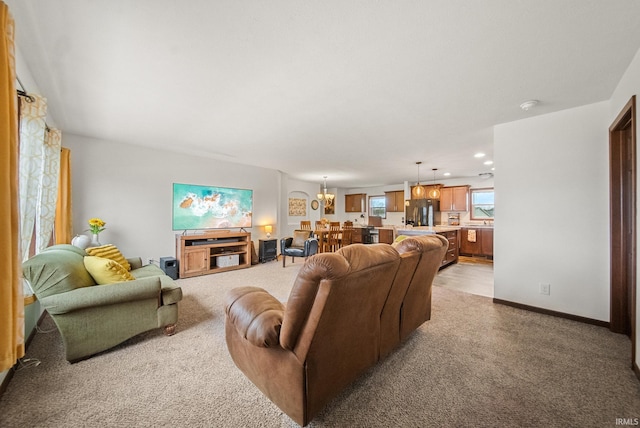 carpeted living room featuring recessed lighting, baseboards, and a chandelier