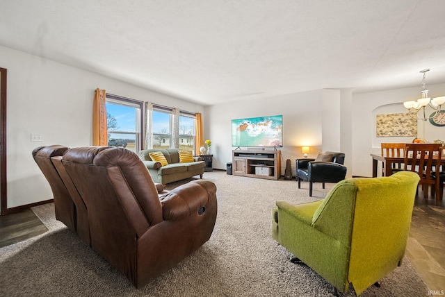 living room featuring baseboards and a chandelier