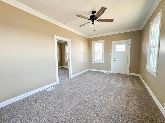 unfurnished room featuring crown molding, baseboards, and visible vents