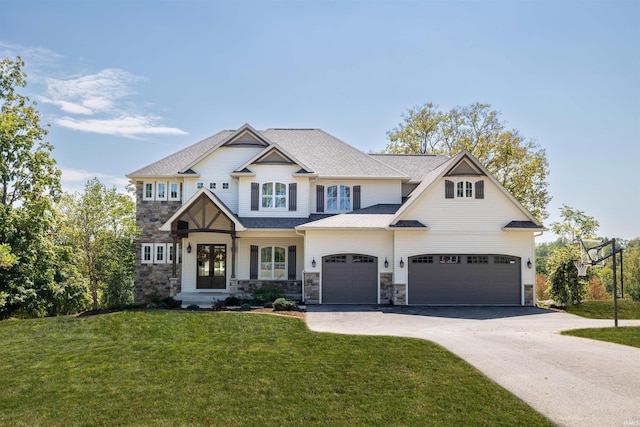 craftsman-style house with driveway, a front lawn, stone siding, french doors, and a garage