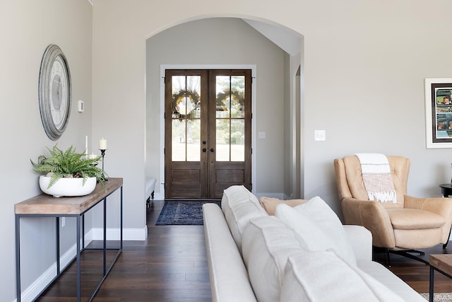 entrance foyer featuring baseboards, dark wood-style flooring, french doors, and arched walkways