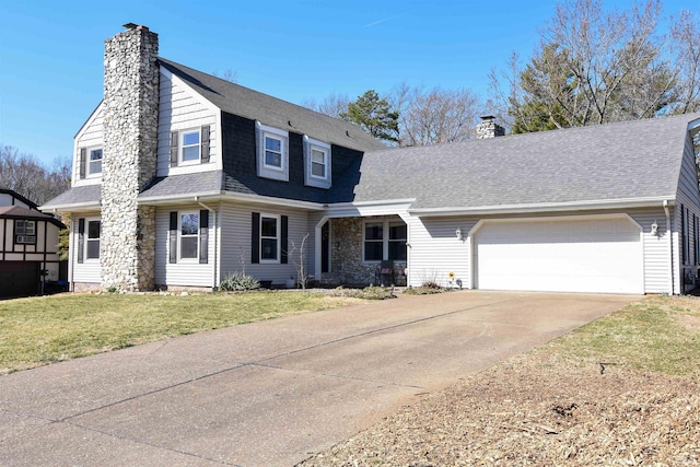 view of front facade with a front lawn, concrete driveway, a chimney, and roof with shingles