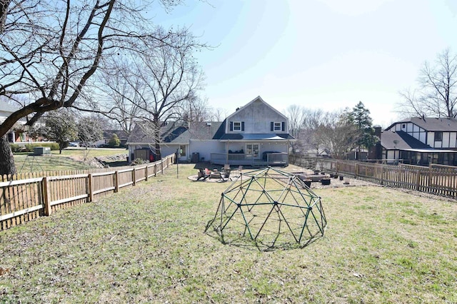 view of yard with an outdoor fire pit and a fenced backyard