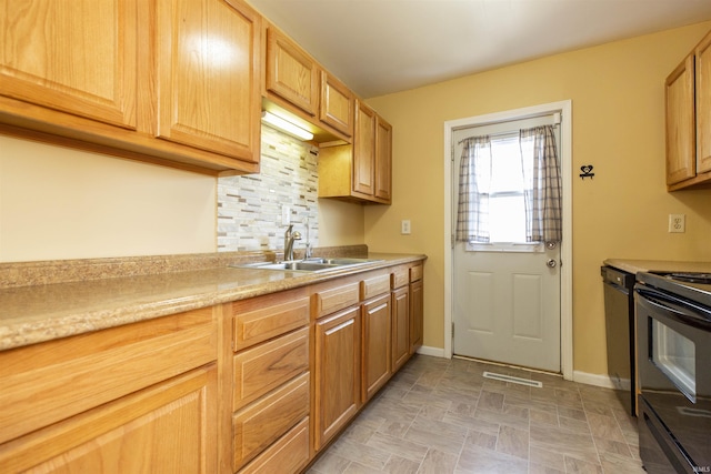 kitchen featuring a sink, backsplash, black appliances, and light countertops