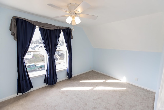 additional living space featuring baseboards, lofted ceiling, carpet, and a ceiling fan