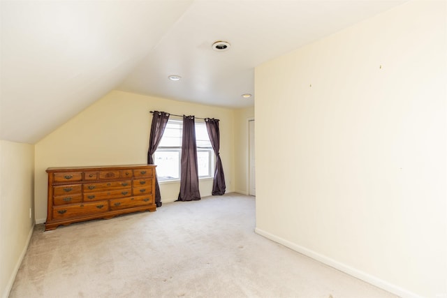 additional living space featuring carpet flooring, baseboards, and vaulted ceiling