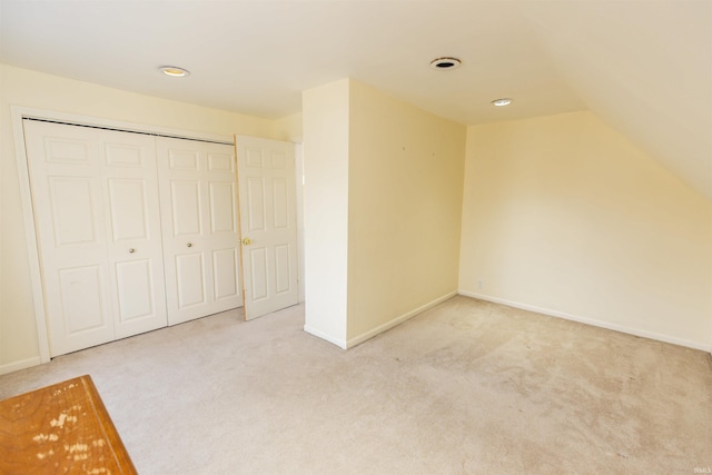 additional living space with baseboards, carpet, and vaulted ceiling