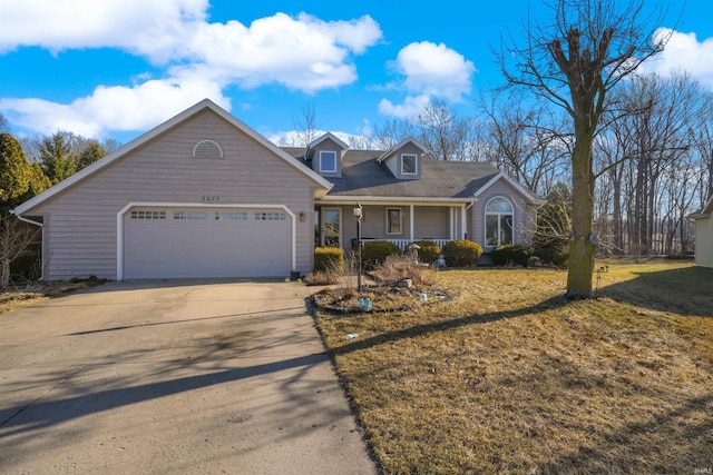 view of front of home with a porch, an attached garage, concrete driveway, and a front yard