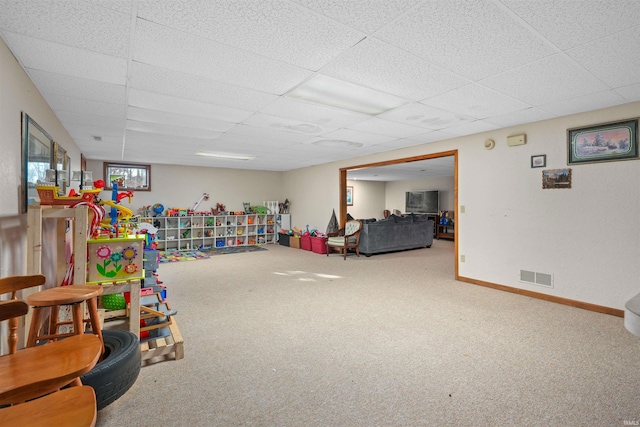 rec room with carpet flooring, baseboards, visible vents, and a paneled ceiling