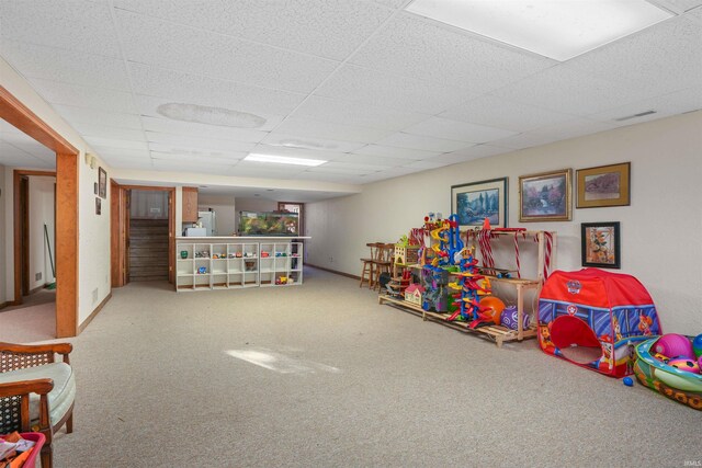 game room featuring a drop ceiling, visible vents, baseboards, and carpet flooring