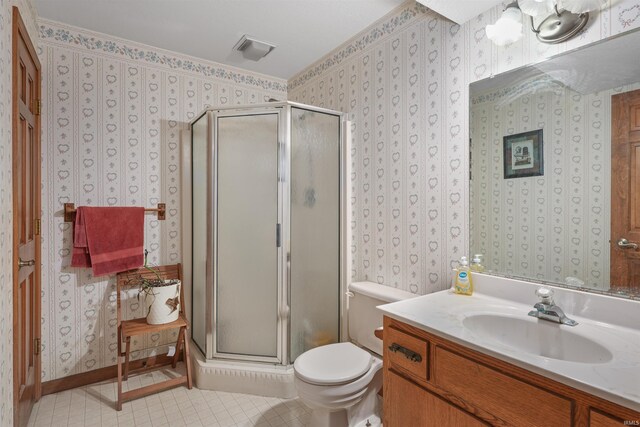 full bathroom featuring vanity, toilet, a shower stall, and wallpapered walls