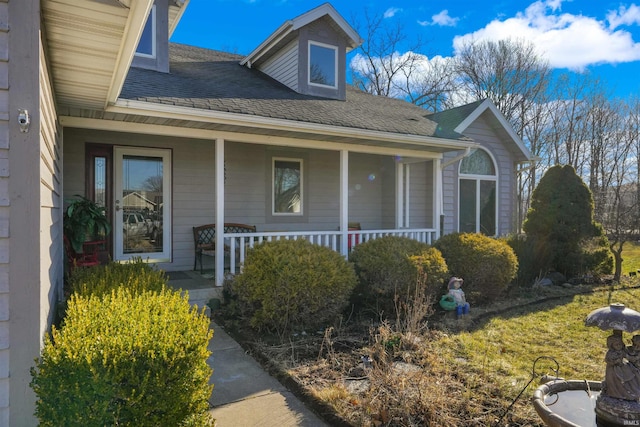 view of front of home with covered porch and roof with shingles