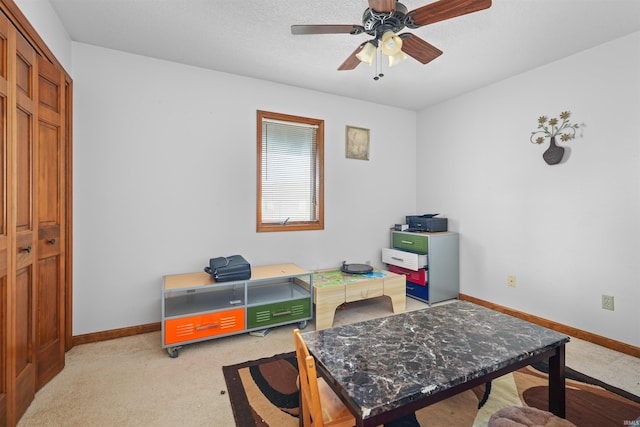 game room featuring light colored carpet, a textured ceiling, baseboards, and ceiling fan