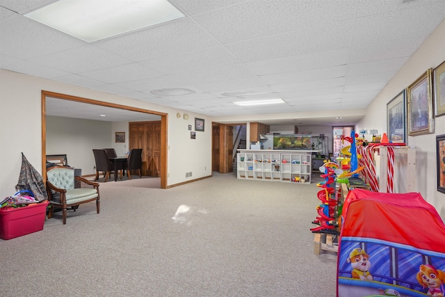 game room with carpet, baseboards, and a paneled ceiling