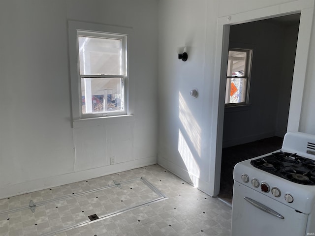 interior space featuring white range with gas stovetop and light floors