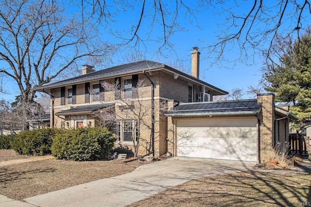 view of front of property featuring concrete driveway, a balcony, brick siding, and a chimney