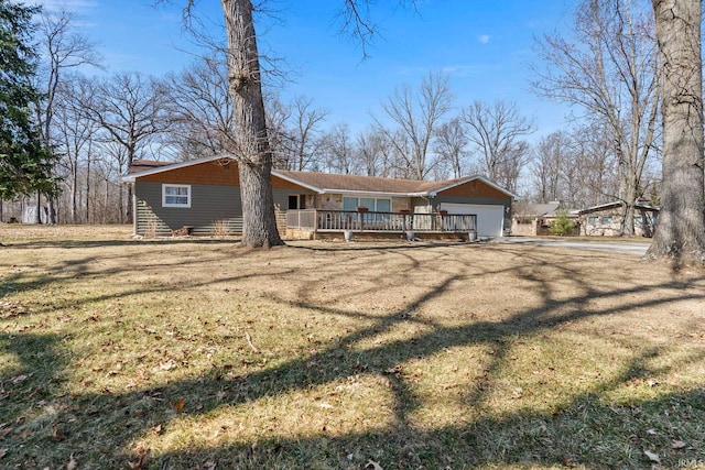 exterior space with a garage, driveway, and a front lawn