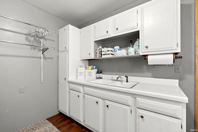 kitchen with white cabinets, light countertops, and a sink