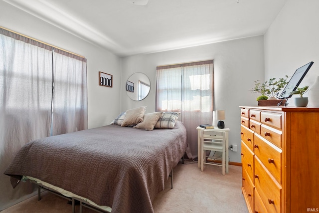 bedroom featuring light colored carpet