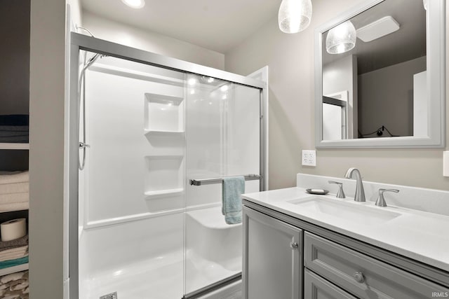 bathroom featuring a shower stall and vanity