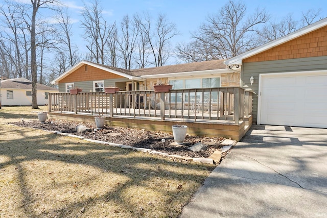 exterior space with a garage, driveway, and a deck