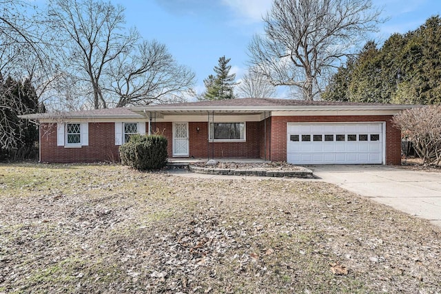 single story home with brick siding, concrete driveway, and a garage