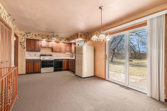 kitchen with light colored carpet, light countertops, hanging light fixtures, brown cabinetry, and white appliances