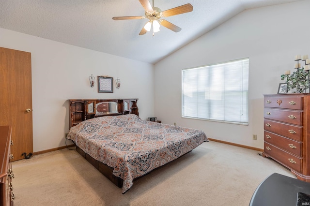 bedroom featuring a textured ceiling, vaulted ceiling, and light carpet